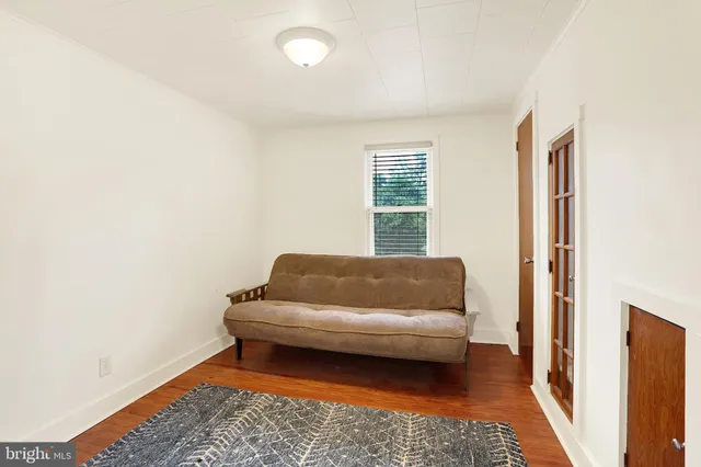 a bedroom with a couch and a rug