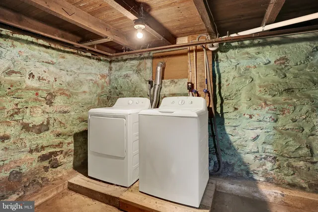 a utility room with a shower and sink