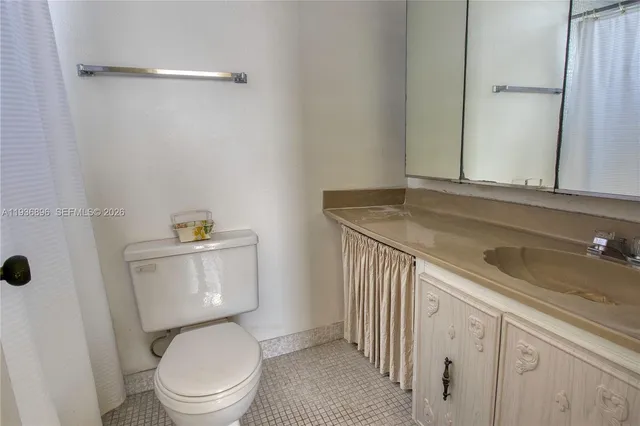 a white toilet sitting next to a bathroom sink