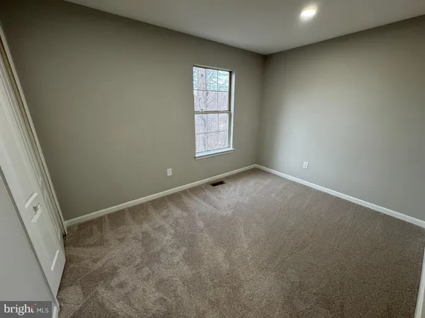 a bathroom with a tub a sink and a large mirror