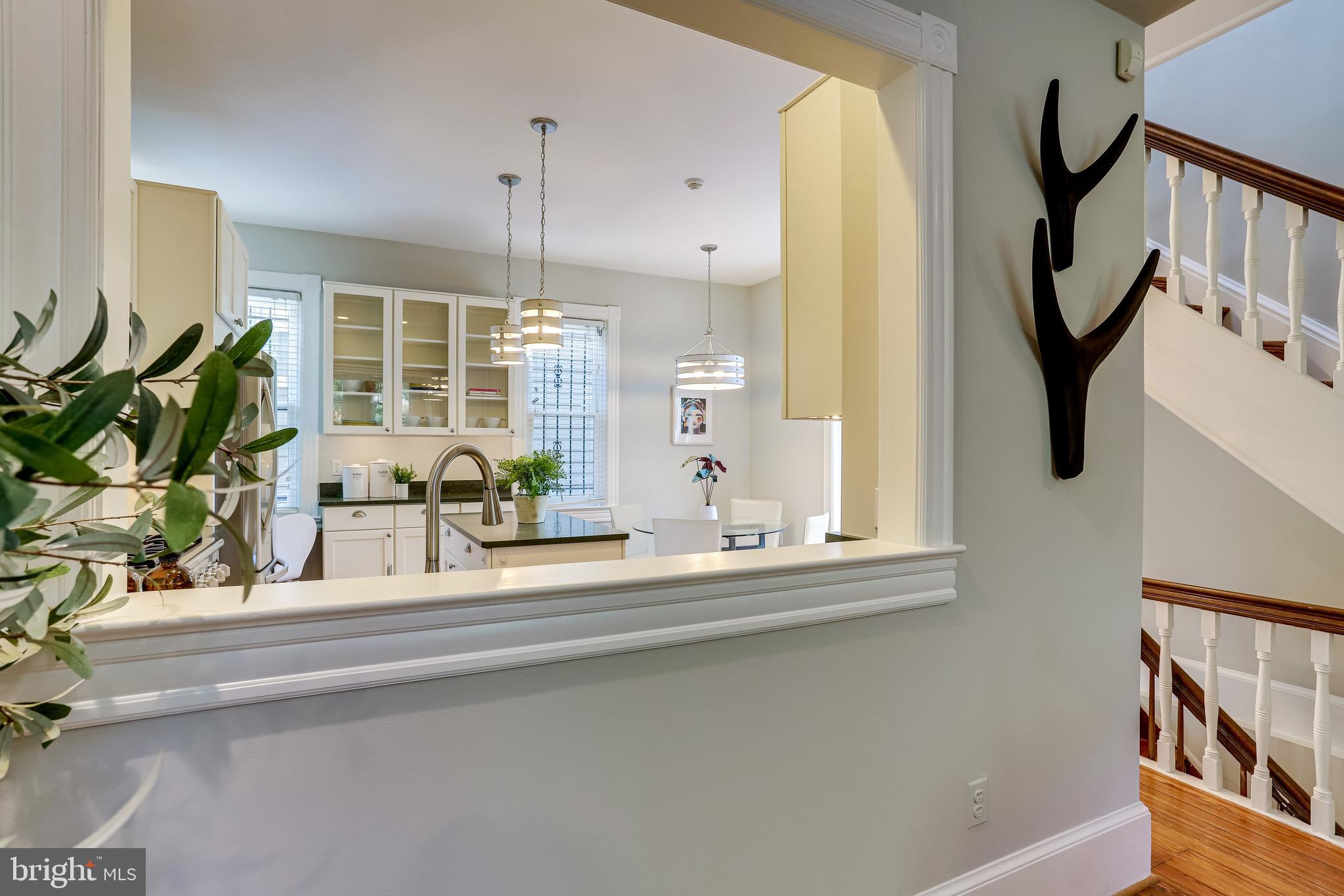 116 9th Street Southeast Washington, DC 20003 - Photo 12 of 56 Large window between living/kitchen defines spaces