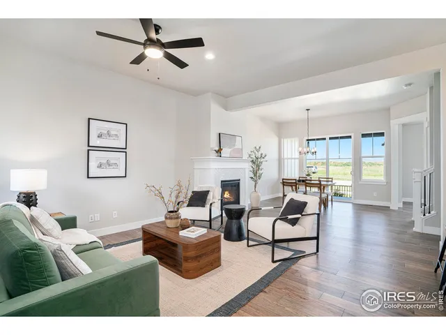 a living room with fireplace furniture and a wooden floor
