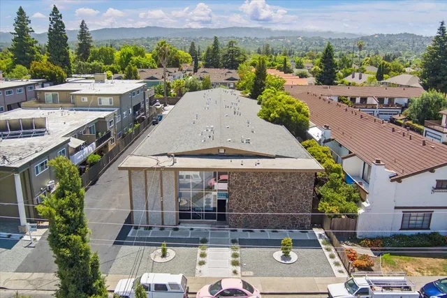 an aerial view of a house with swimming pool and a yard