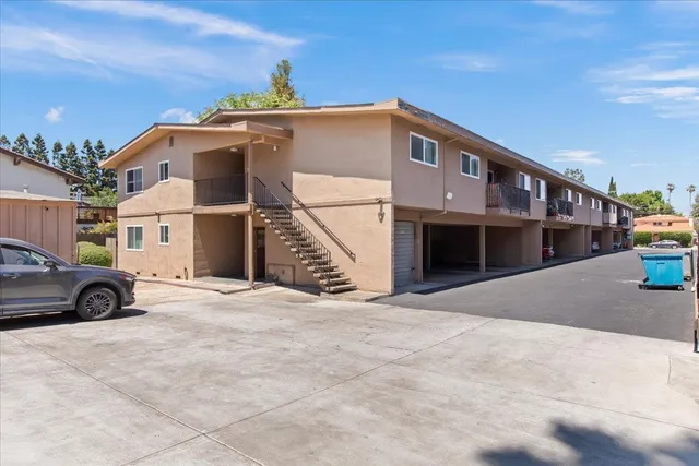 a view of parking area with large trees