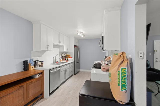 a kitchen with stainless steel appliances kitchen island granite countertop a sink and stove