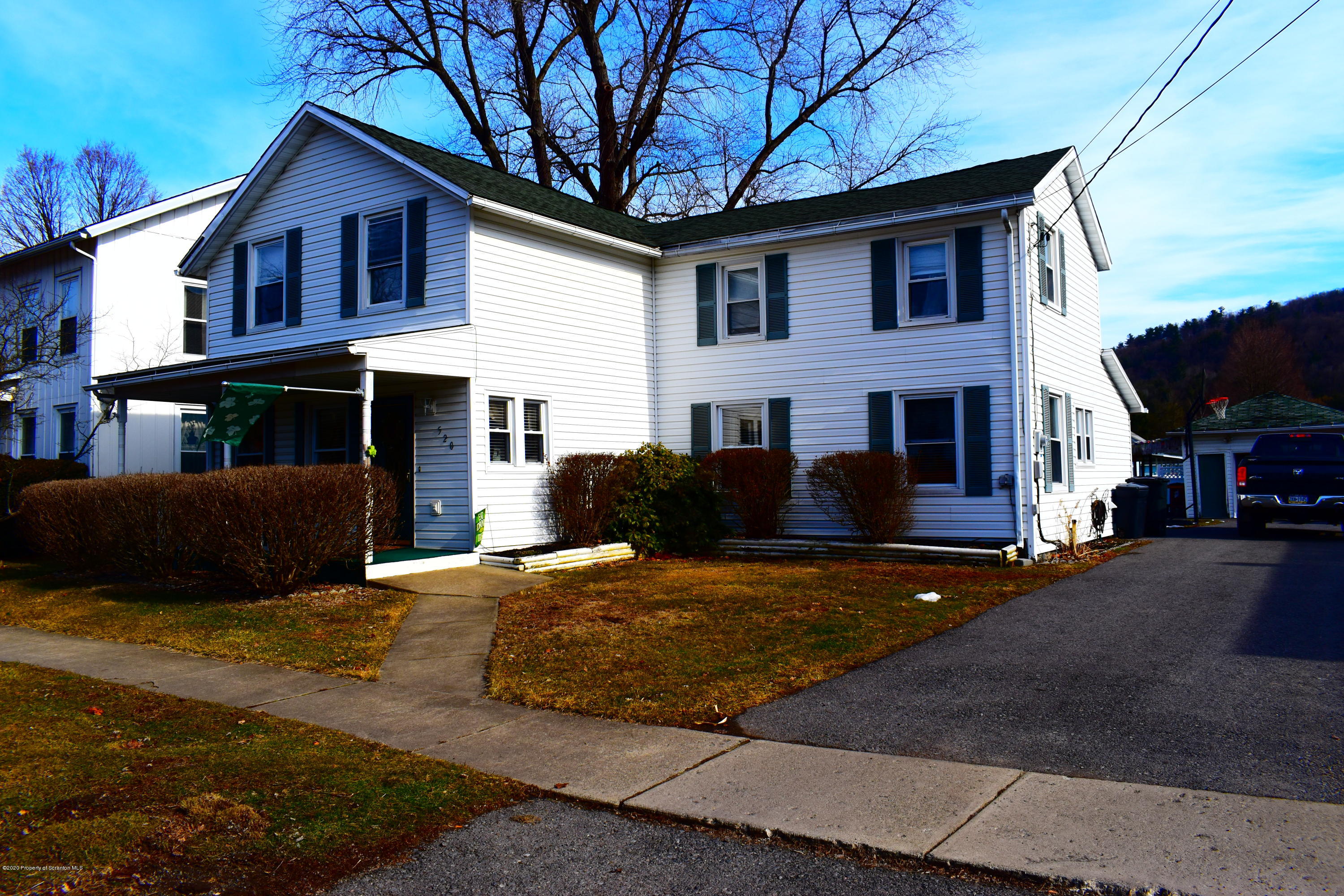 520 Main Street Great Bend, PA 18821 - Photo 1 of 34 a front view of house with yard and trees in the background