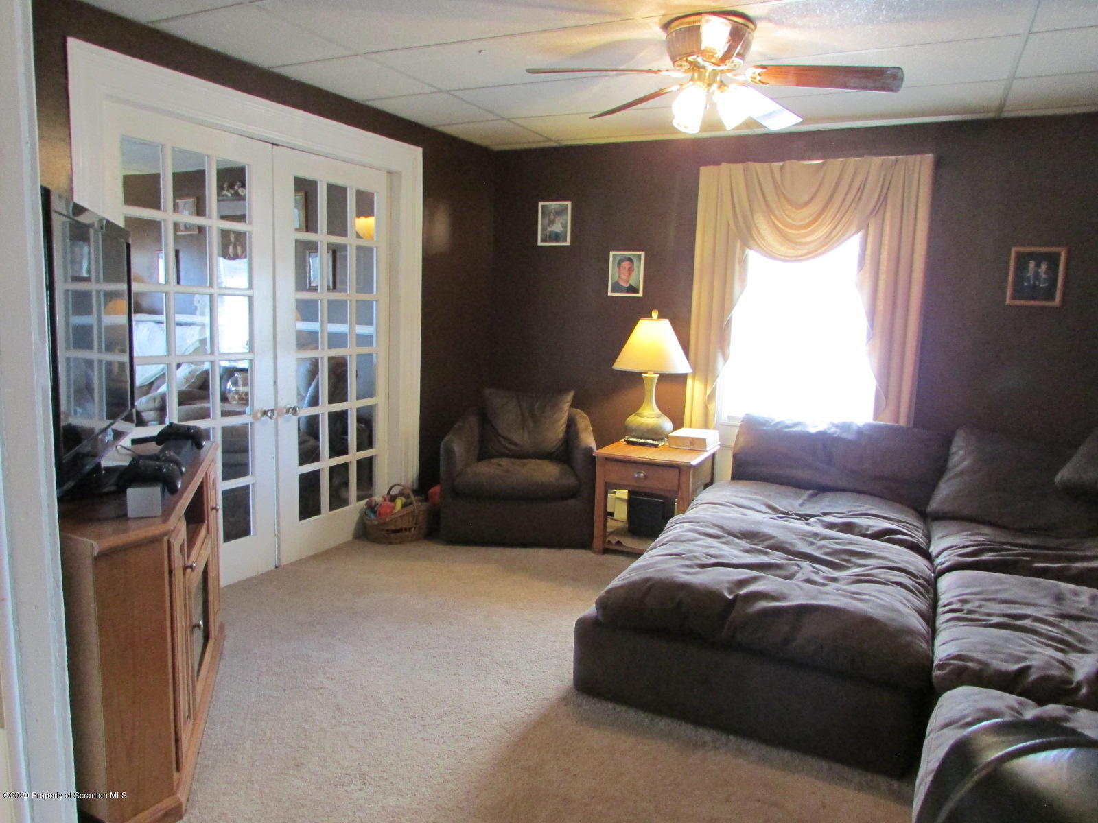 520 Main Street Great Bend, PA 18821 - Photo 15 of 34 a living room with furniture a chandelier and a window