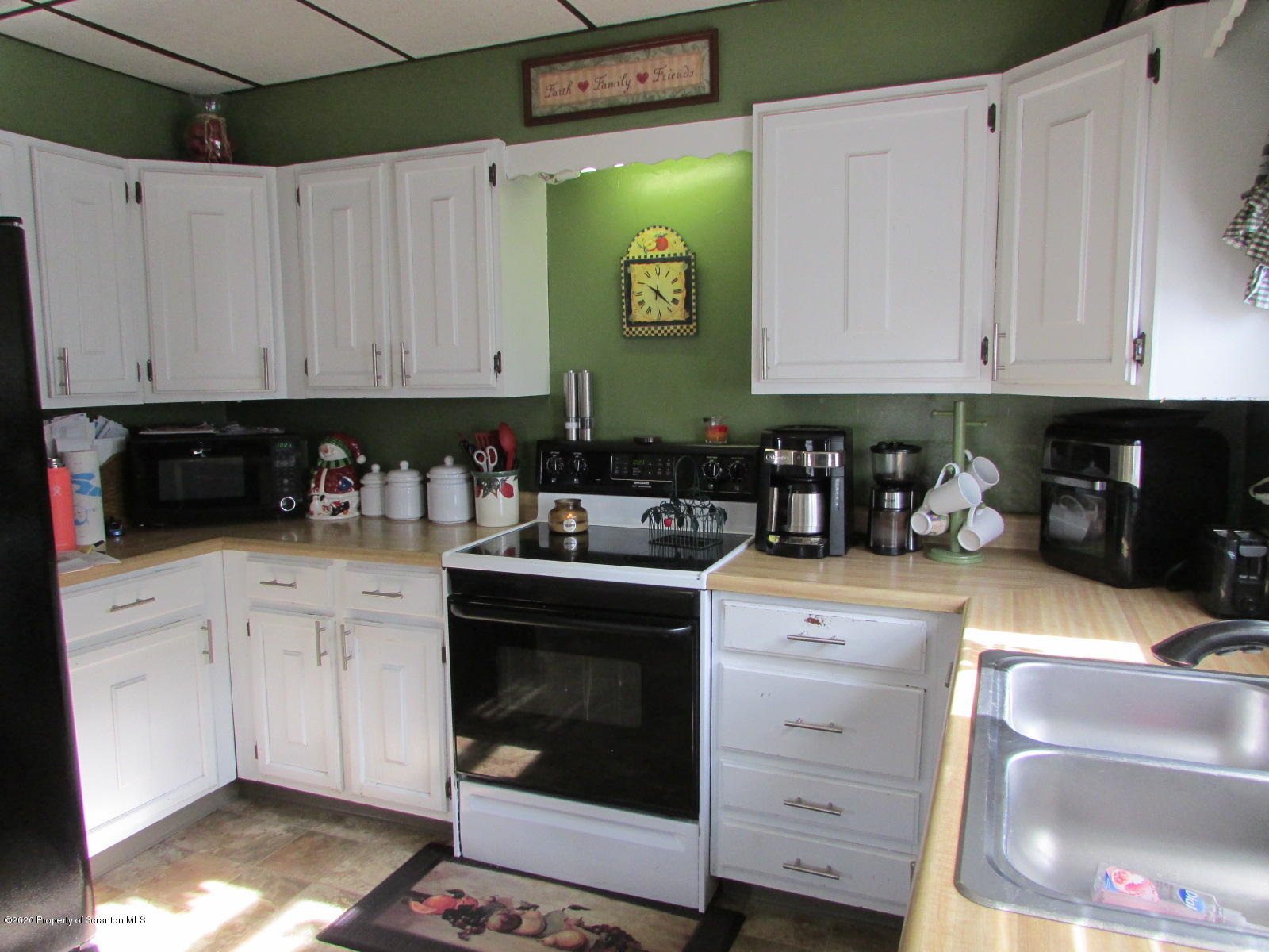520 Main Street Great Bend, PA 18821 - Photo 5 of 34 a kitchen with stainless steel appliances granite countertop a stove a sink and a white cabinets