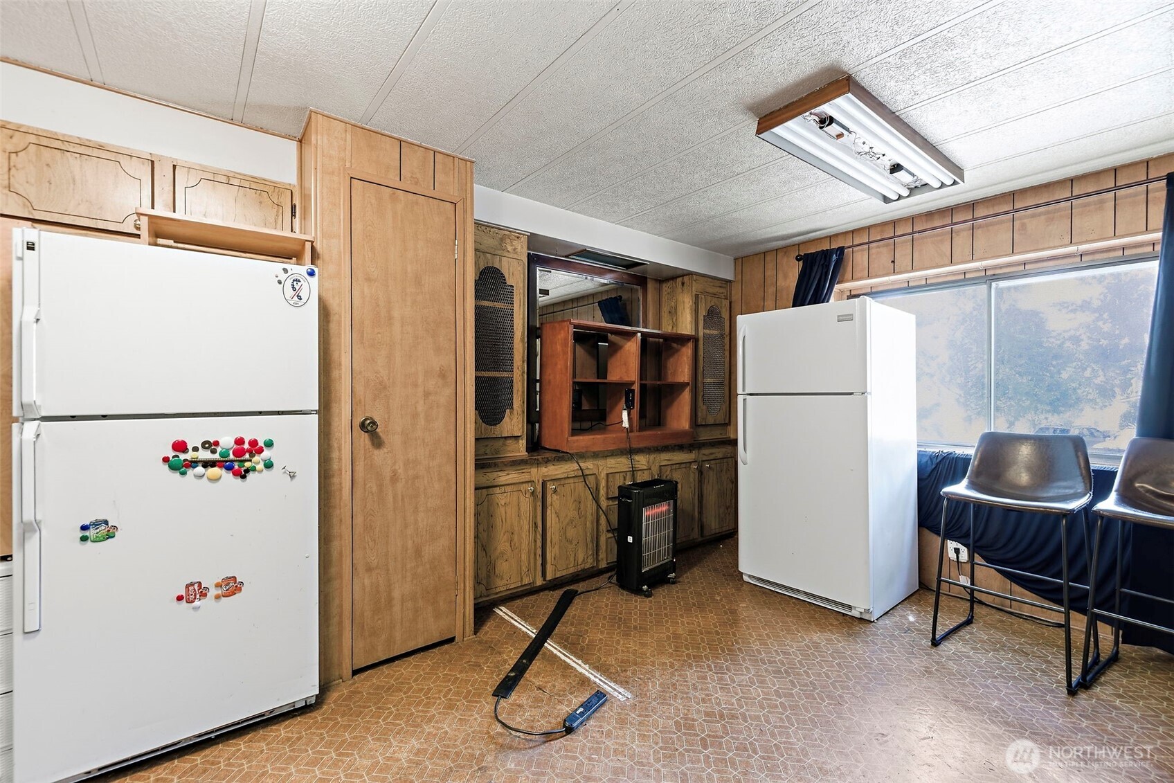 3333 228th Street Southeast, Unit 99 Bothell, WA 98021 - Photo 11 of 27 a room with furniture a refrigerator and a window