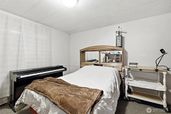 a bedroom with a bed and a large window