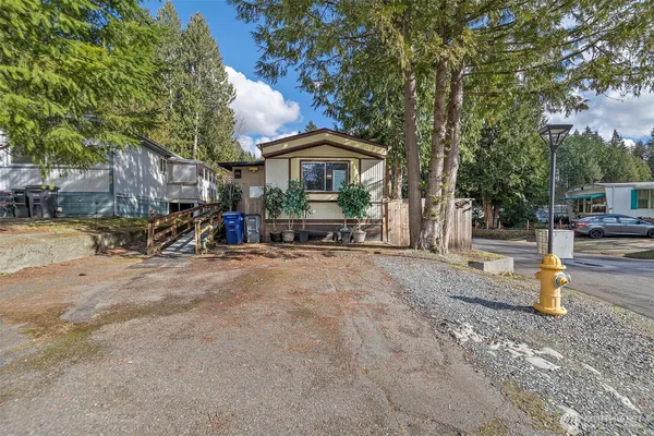 a view of a house with wooden fence