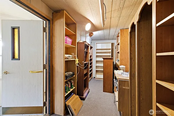 a kitchen with refrigerator and cabinets