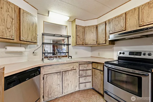 a room with furniture a refrigerator and a window