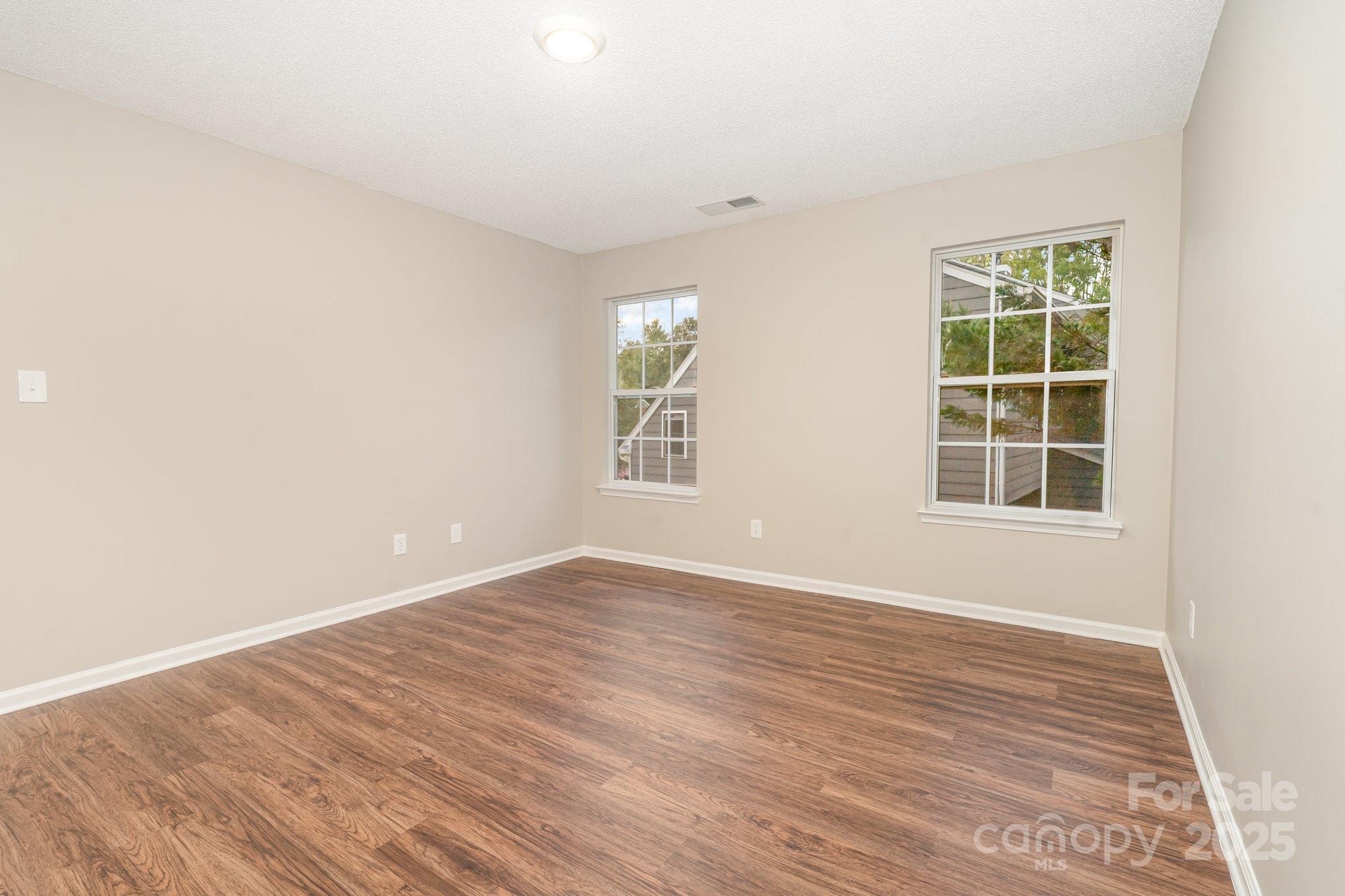 7527 Henderson Park Road Huntersville, NC 28078 - Photo 11 of 18 an empty room with wooden floor and windows
