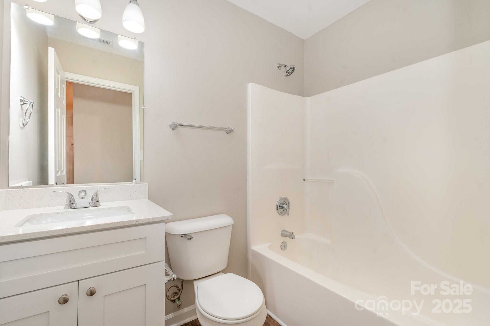 7527 Henderson Park Road Huntersville, NC 28078 - Photo 14 of 18 a bathroom with a toilet a sink a mirror and bathtub