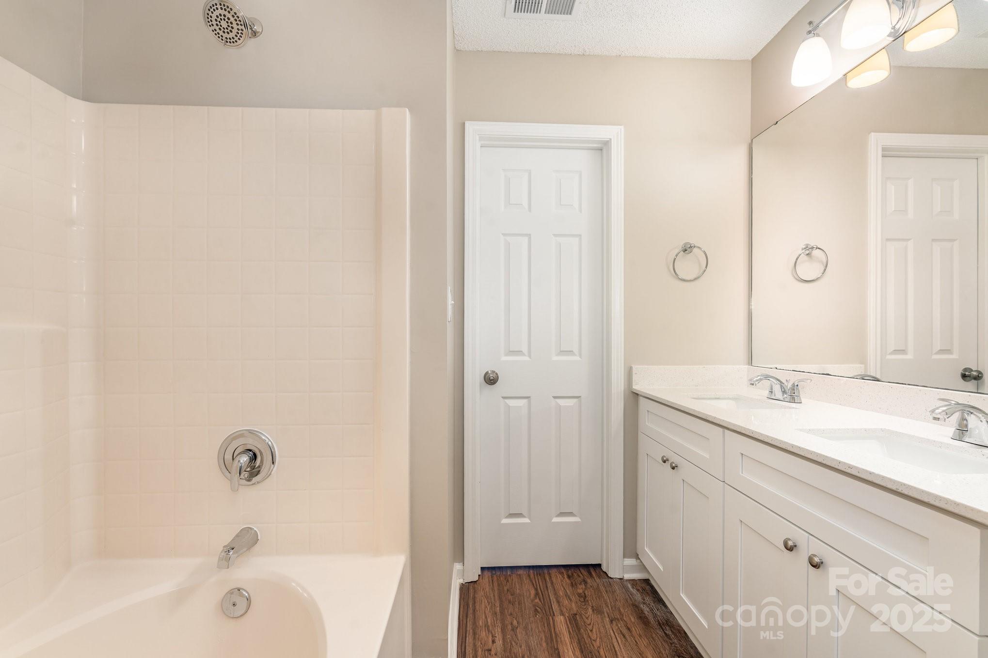 7527 Henderson Park Road Huntersville, NC 28078 - Photo 15 of 18 a bathroom with a sink a mirror and a bathtub