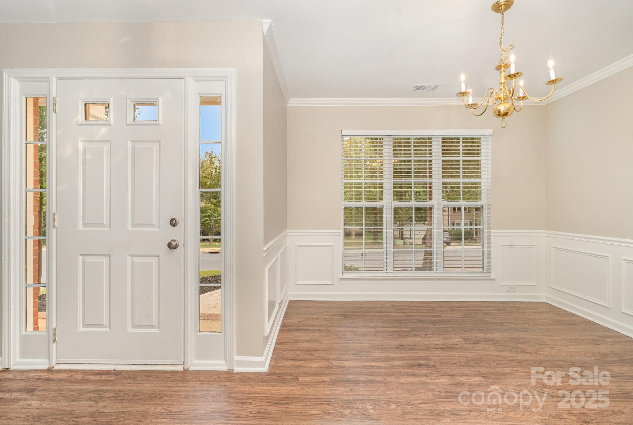 7527 Henderson Park Road Huntersville, NC 28078 - Photo 4 of 18 a view of an empty room with wooden floor and a window