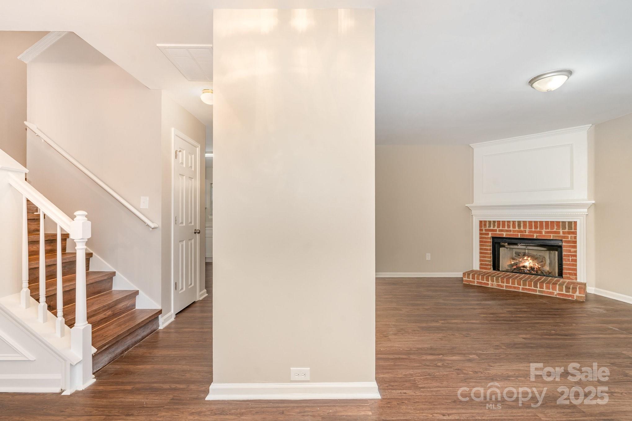 7527 Henderson Park Road Huntersville, NC 28078 - Photo 5 of 18 a view of a livingroom with wooden floor and a fireplace
