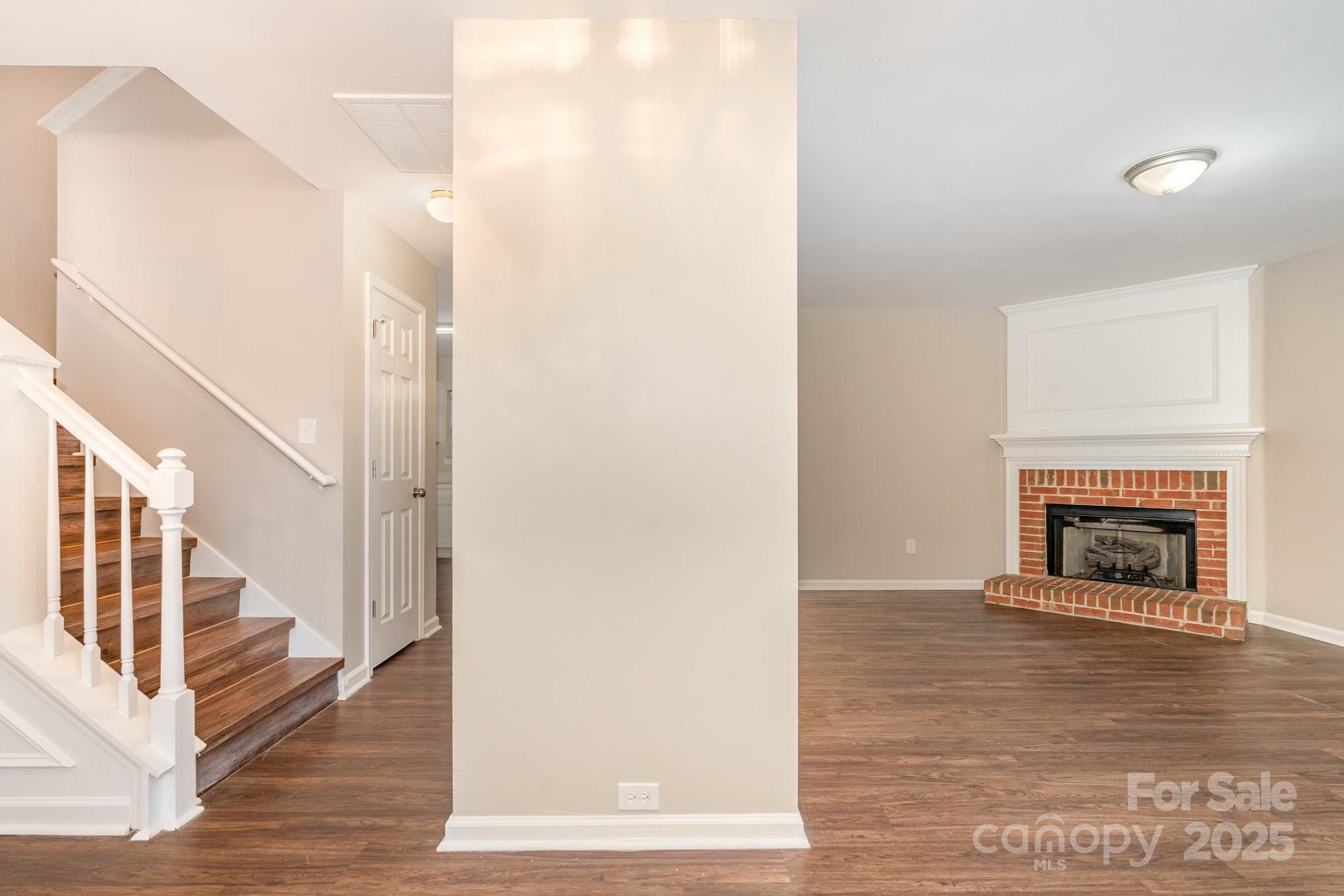 7527 Henderson Park Road Huntersville, NC 28078 - Photo 6 of 18 a view of a hallway with wooden floor and a fireplace