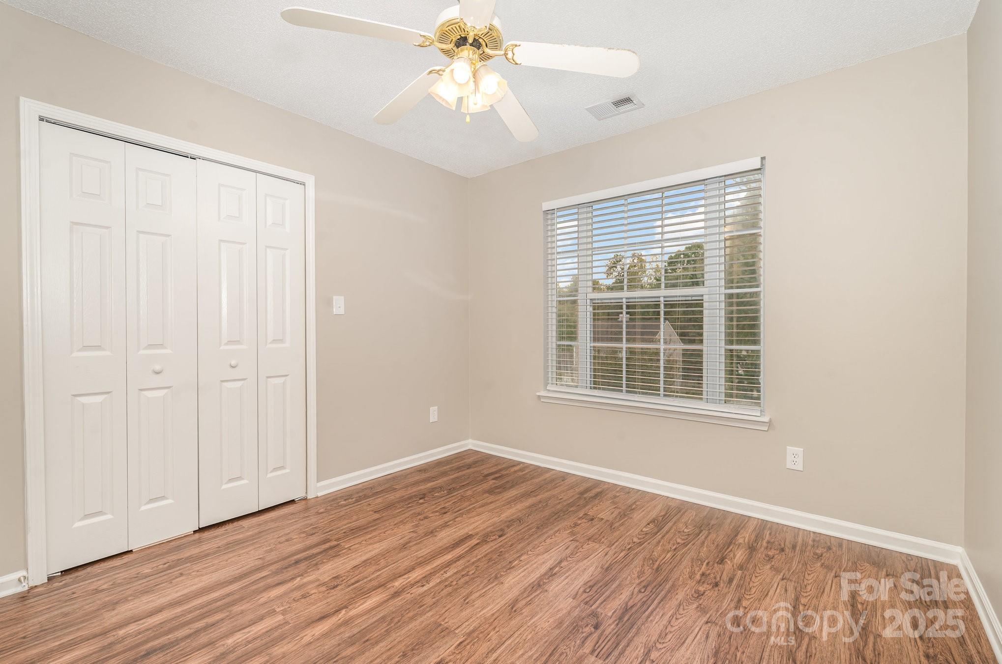 7527 Henderson Park Road Huntersville, NC 28078 - Photo 10 of 18 a view of an empty room with wooden floor and a window