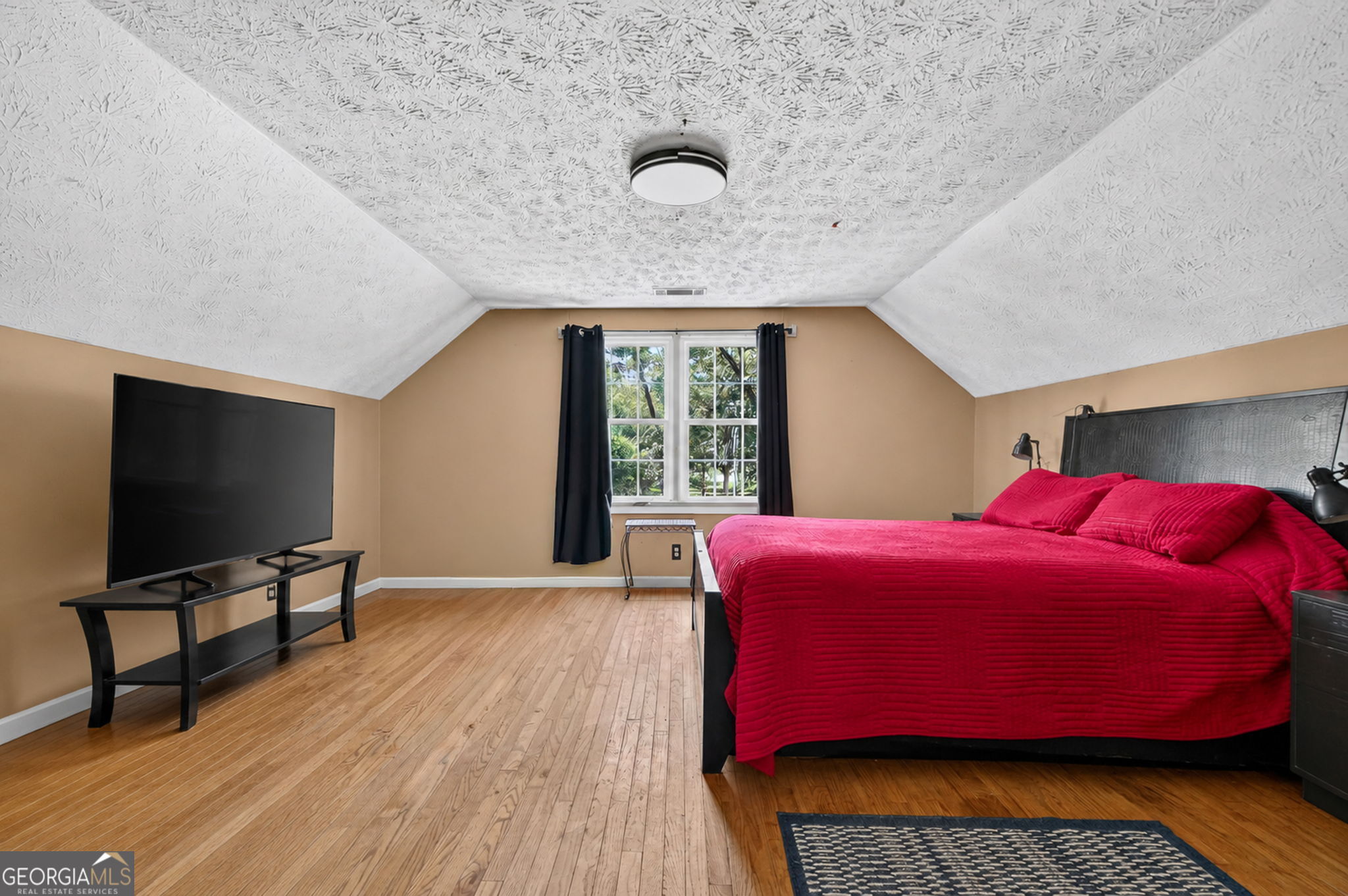 169 Silver Dollar Road Barnesville, GA 30204 - Photo 42 of 66 Photo Edit/AI staged to show room, high ceiling, wood flooring, spiral staircase, could be used as Bedroom/ Bonus Room