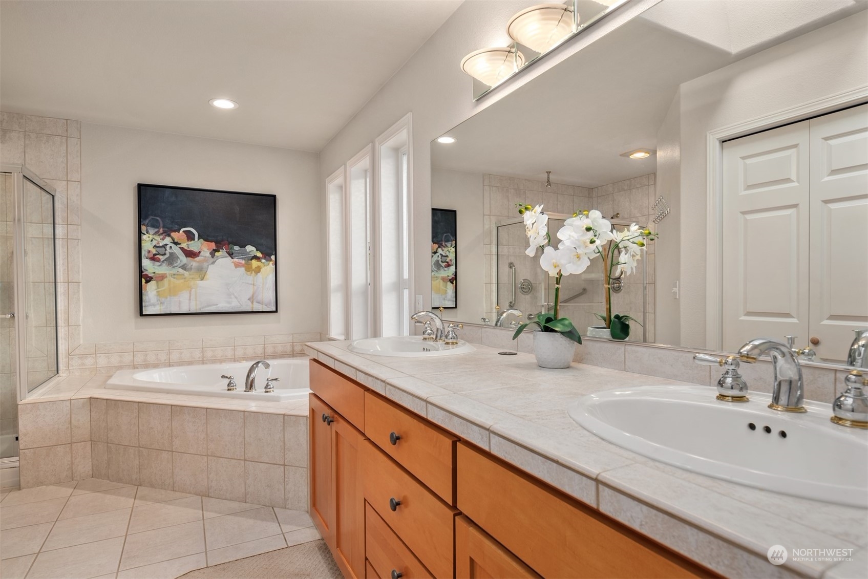 16034 68th Avenue West Edmonds, WA 98026 - Photo 17 of 32 a spacious bathroom with a double vanity sink a mirror and a bathtub