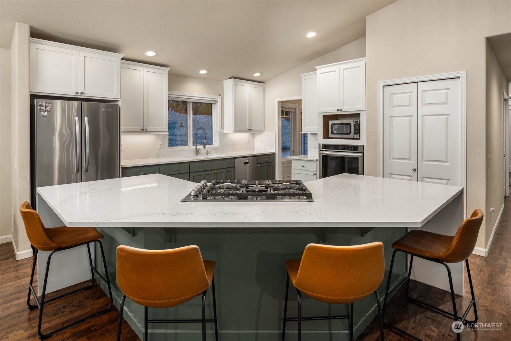 16034 68th Avenue West Edmonds, WA 98026 - Photo 9 of 32 a kitchen with stainless steel appliances granite countertop a stove a refrigerator a kitchen island with chairs and refrigerator
