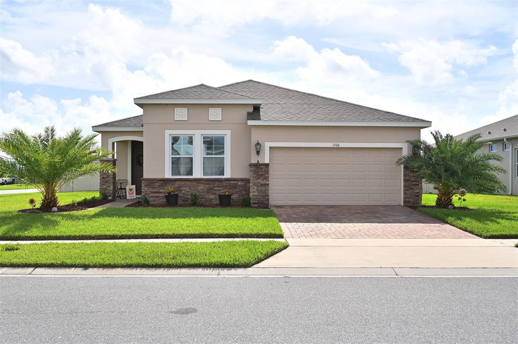 a front view of a house with a yard and garage