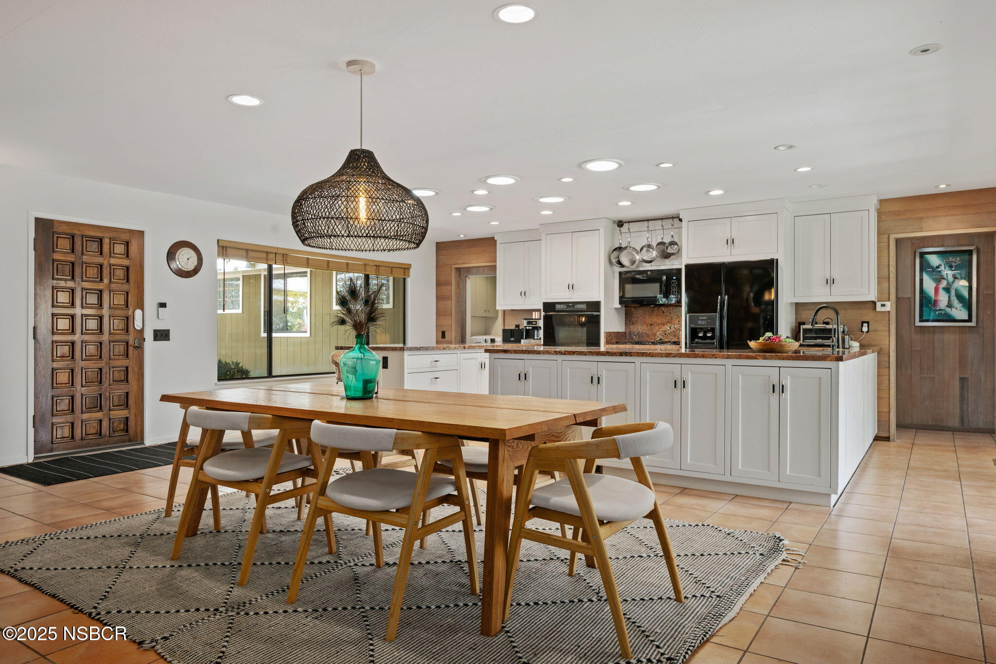 137 3rd Street Solvang, CA 93463 - Photo 14 of 48 a kitchen with stainless steel appliances kitchen island granite countertop a dining table chairs sink and white cabinets
