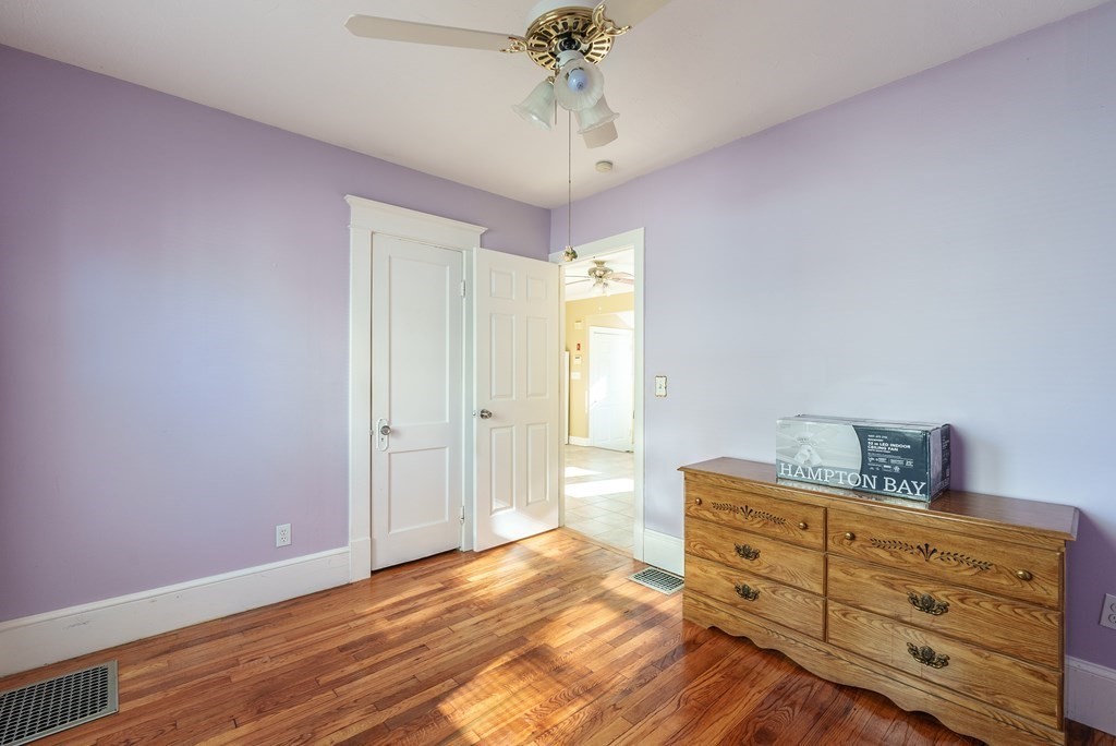 127 Webber Street Springfield, MA 01108 - Photo 12 of 33 a bedroom with a bed and a chandelier fan