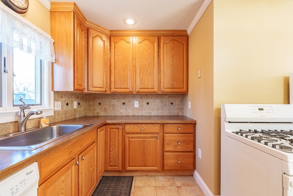 127 Webber Street Springfield, MA 01108 - Photo 15 of 33 a kitchen with a sink stove and cabinets