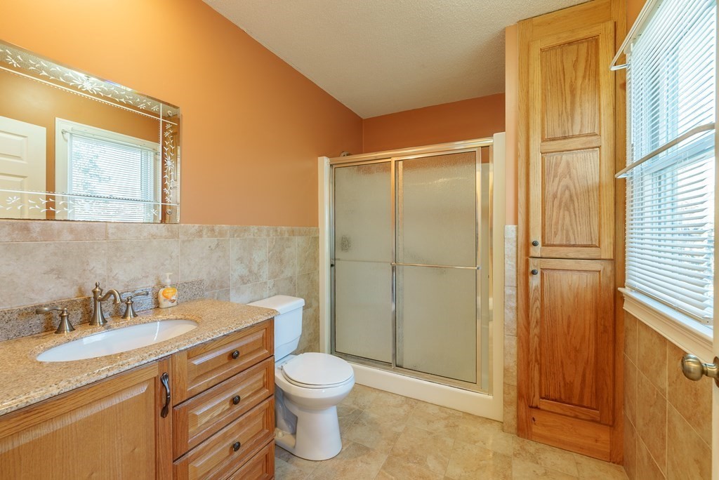 127 Webber Street Springfield, MA 01108 - Photo 17 of 33 a bathroom with a granite countertop sink toilet and shower