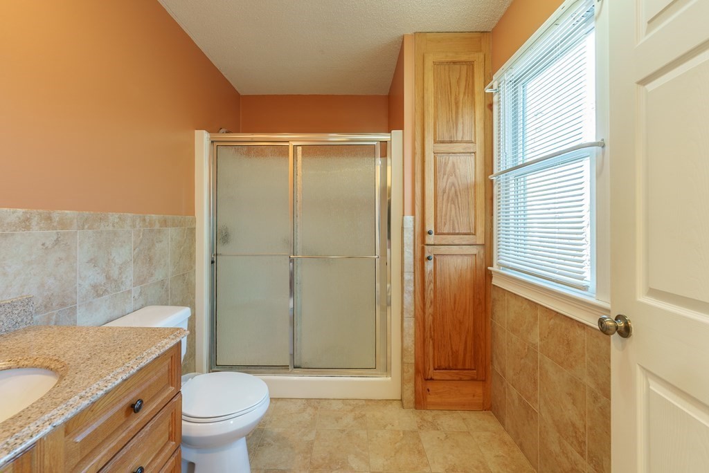 127 Webber Street Springfield, MA 01108 - Photo 18 of 33 a bathroom with a granite countertop toilet a sink and a bathtub