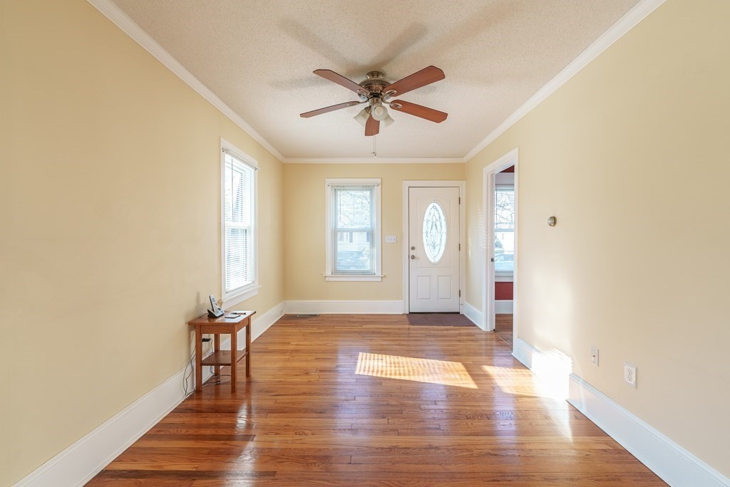 127 Webber Street Springfield, MA 01108 - Photo 2 of 33 a view of an empty room with wooden floor and a window