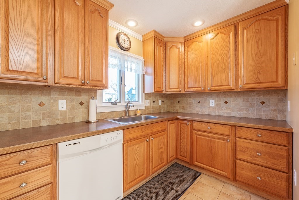 127 Webber Street Springfield, MA 01108 - Photo 4 of 33 a kitchen with stainless steel appliances granite countertop a sink window and cabinets