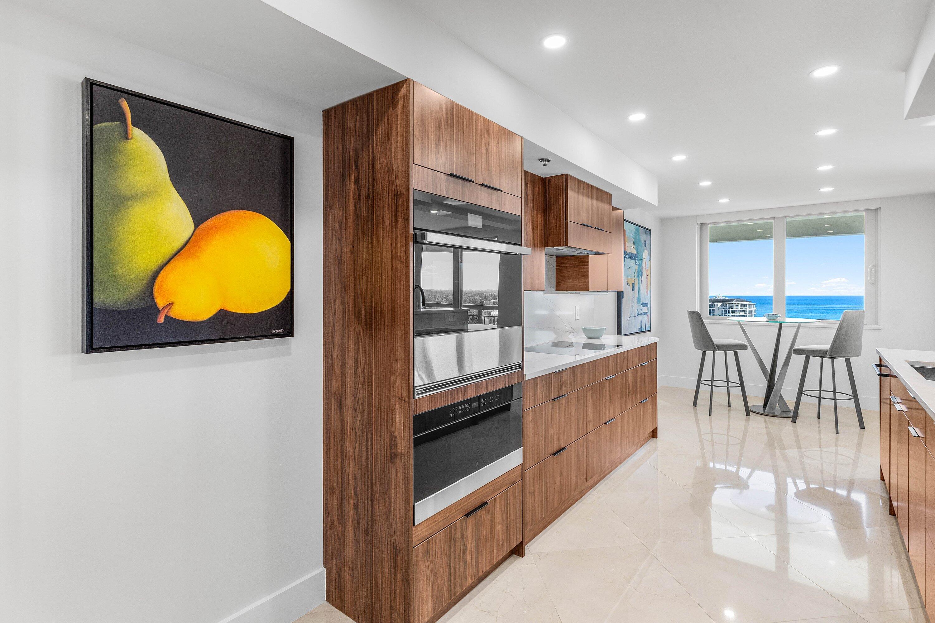 901 East Camino Real, Unit 15D Boca Raton, FL 33432 - Photo 13 of 42 a kitchen with stainless steel appliances granite countertop a stove and a refrigerator