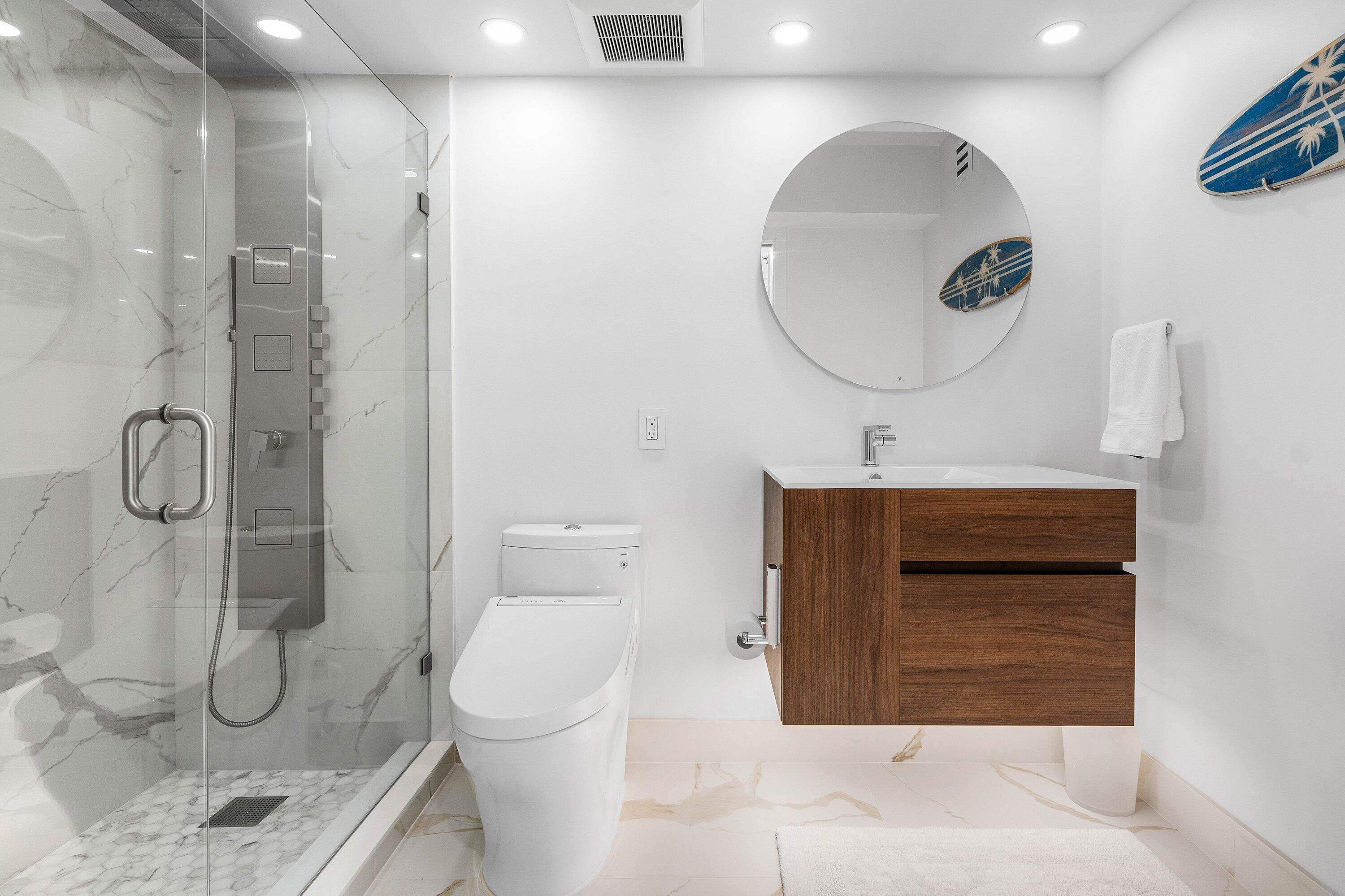 901 East Camino Real, Unit 15D Boca Raton, FL 33432 - Photo 23 of 42 a bathroom with a sink a toilet and shower