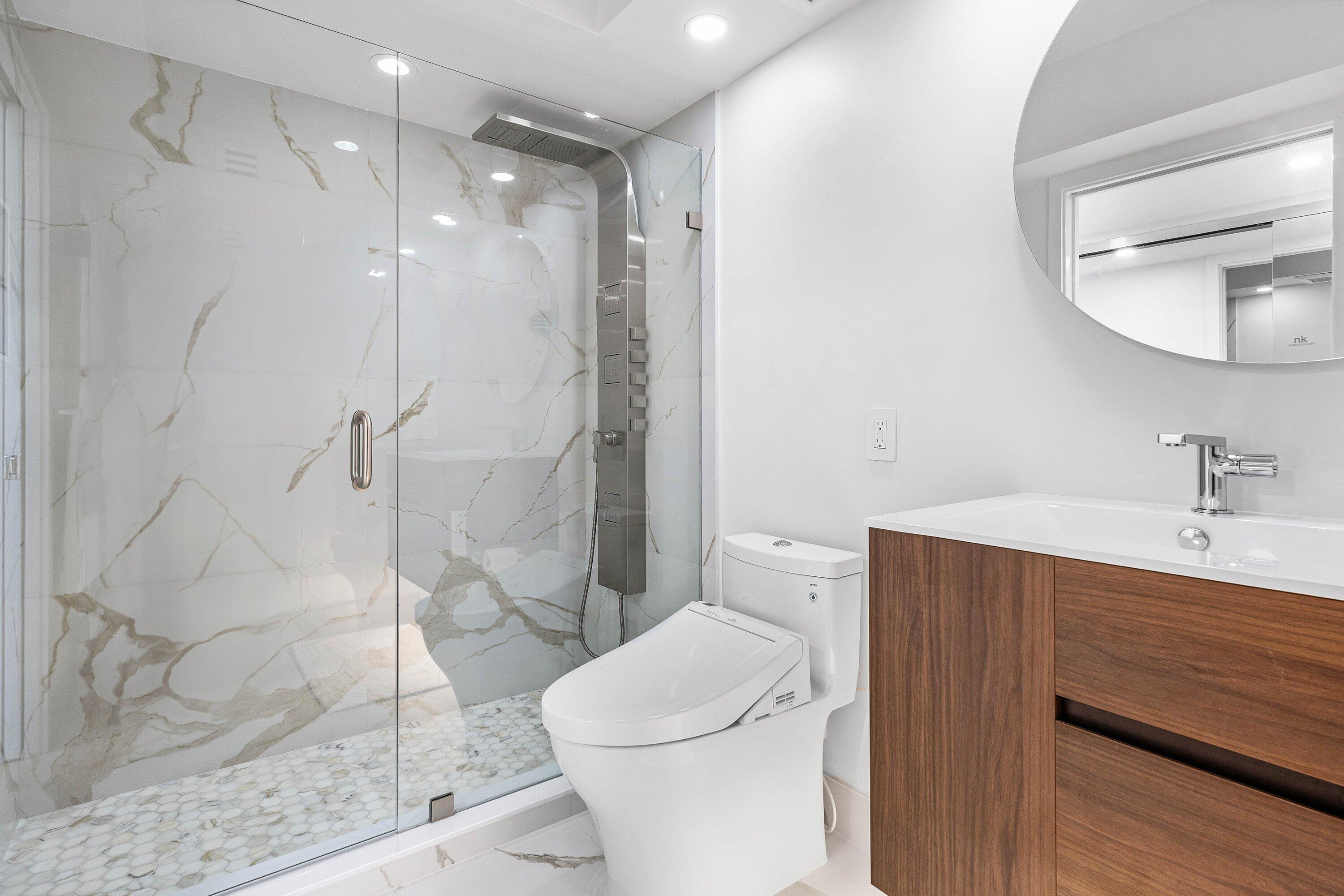 901 East Camino Real, Unit 15D Boca Raton, FL 33432 - Photo 24 of 42 a bathroom with a sink a toilet and shower