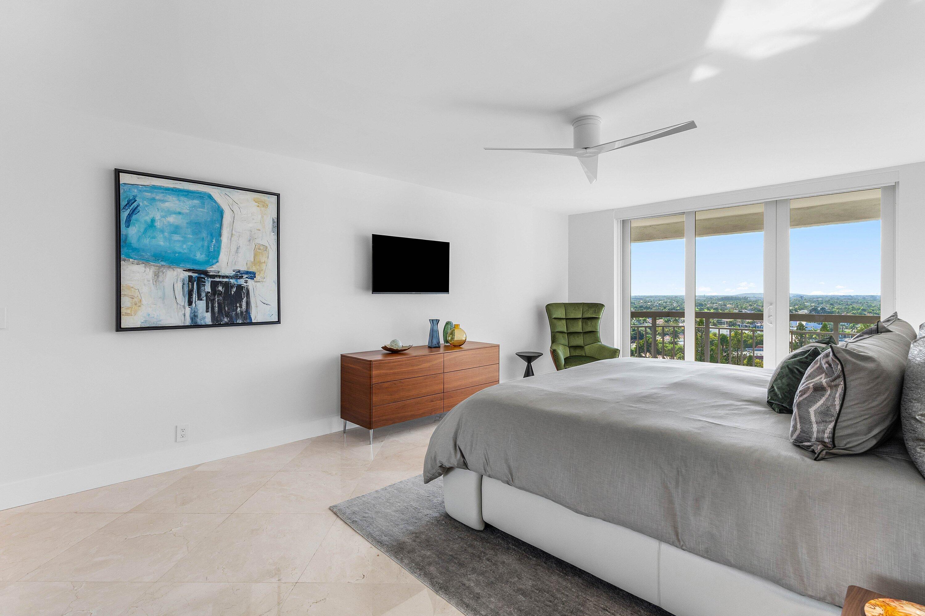 901 East Camino Real, Unit 15D Boca Raton, FL 33432 - Photo 27 of 42 a bedroom with furniture and a flat screen tv