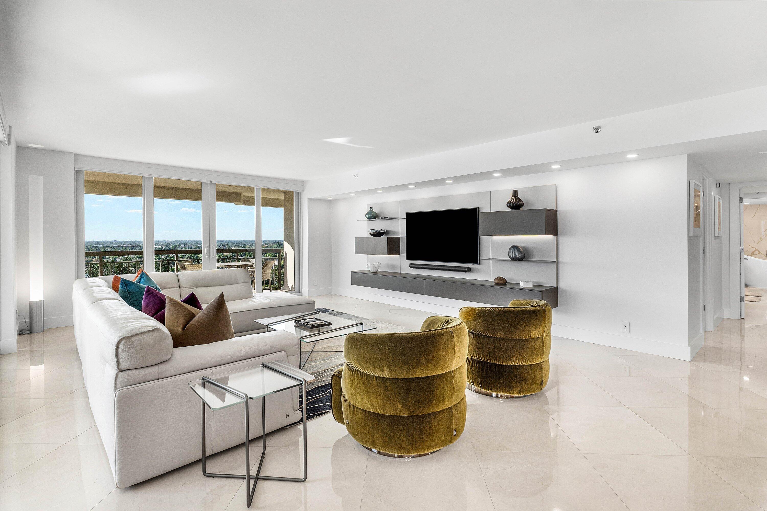 901 East Camino Real, Unit 15D Boca Raton, FL 33432 - Photo 8 of 42 a living room with furniture and a flat screen tv