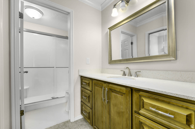 1822 East 9800th Street South Sandy, UT 84092 - Photo 16 of 38 Bathroom with a shower stall, vanity, and ornamental molding