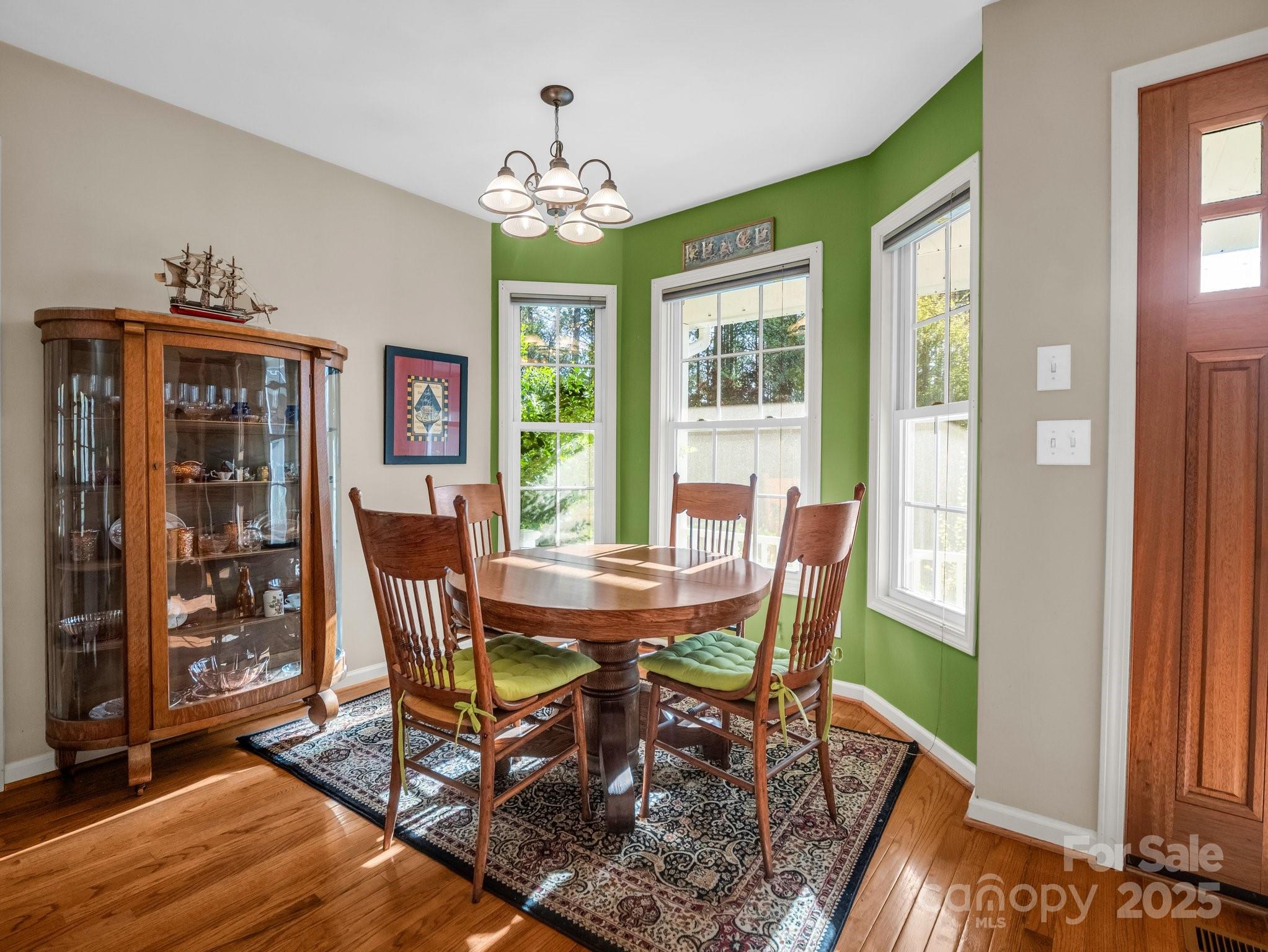 940 Hugh Champion Road Tryon, NC 28782 - Photo 14 of 36 a view of a dining room with furniture a chandelier and wooden floor
