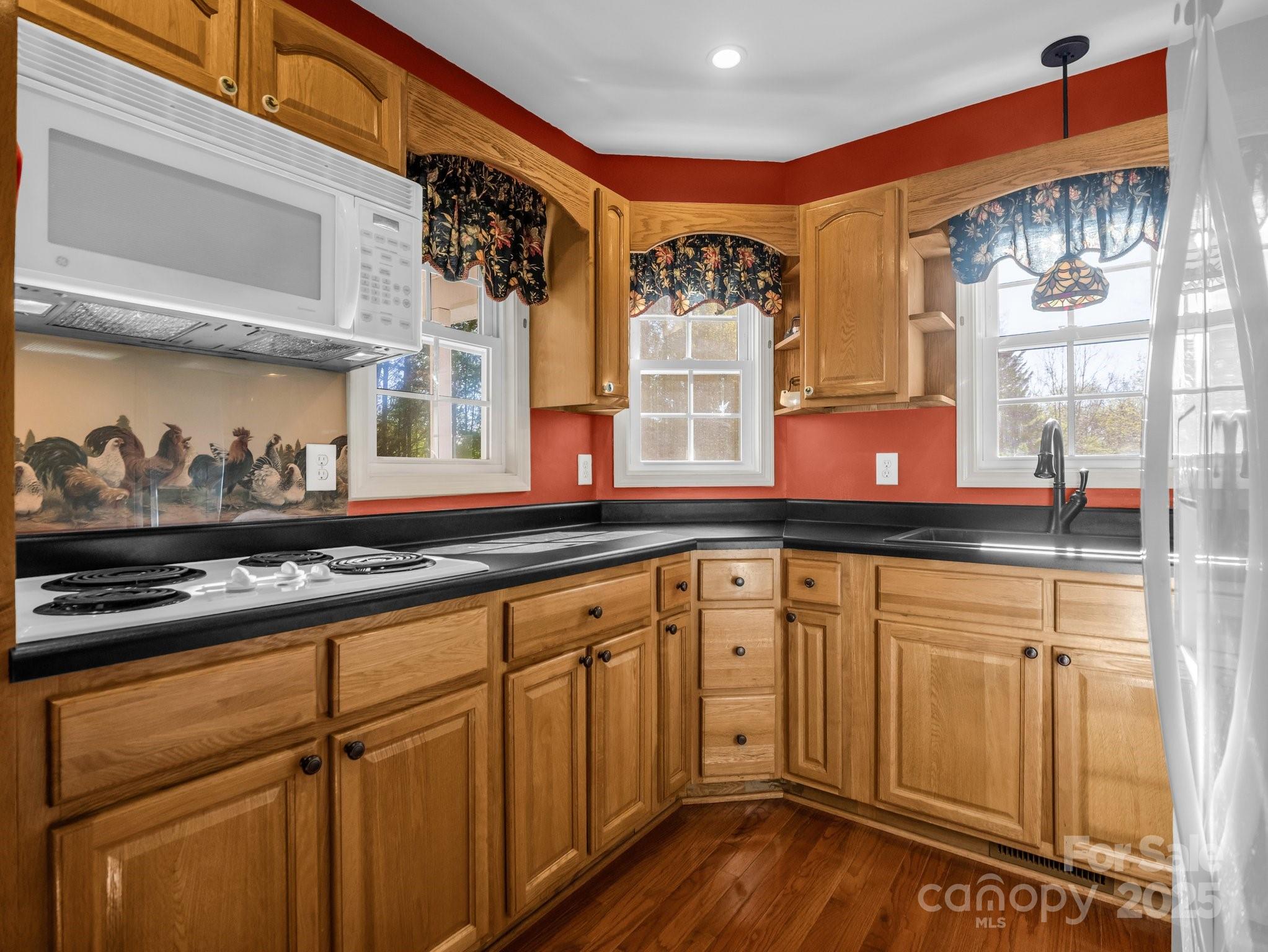 940 Hugh Champion Road Tryon, NC 28782 - Photo 17 of 36 a kitchen with stainless steel appliances granite countertop a stove and a sink