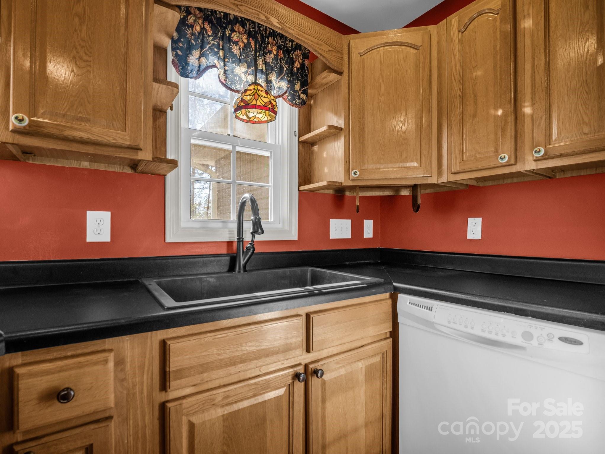 940 Hugh Champion Road Tryon, NC 28782 - Photo 18 of 36 a kitchen with stainless steel appliances granite countertop white cabinets and a sink