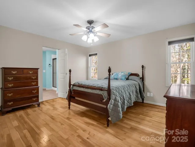 a spacious bedroom with a bed and a chandelier