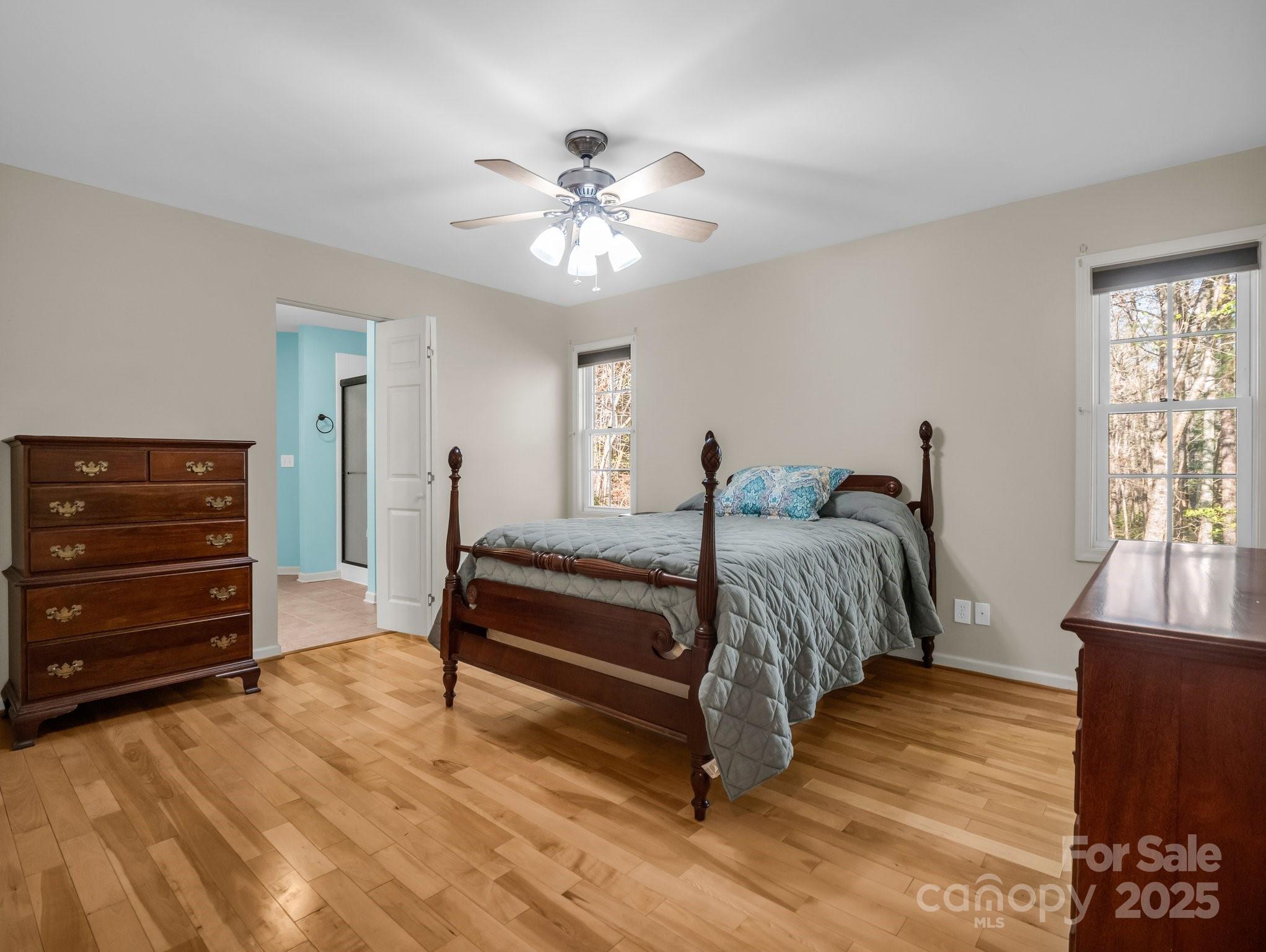 940 Hugh Champion Road Tryon, NC 28782 - Photo 20 of 36 a spacious bedroom with a bed and a chandelier