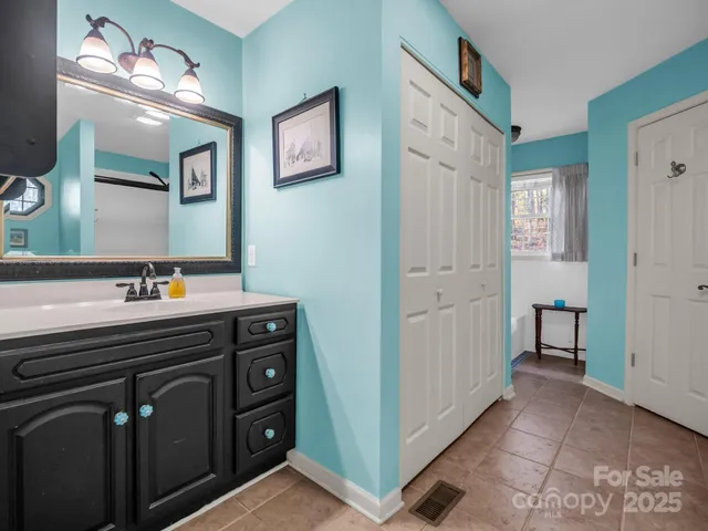 a spacious bathroom with a double vanity sink and a mirror