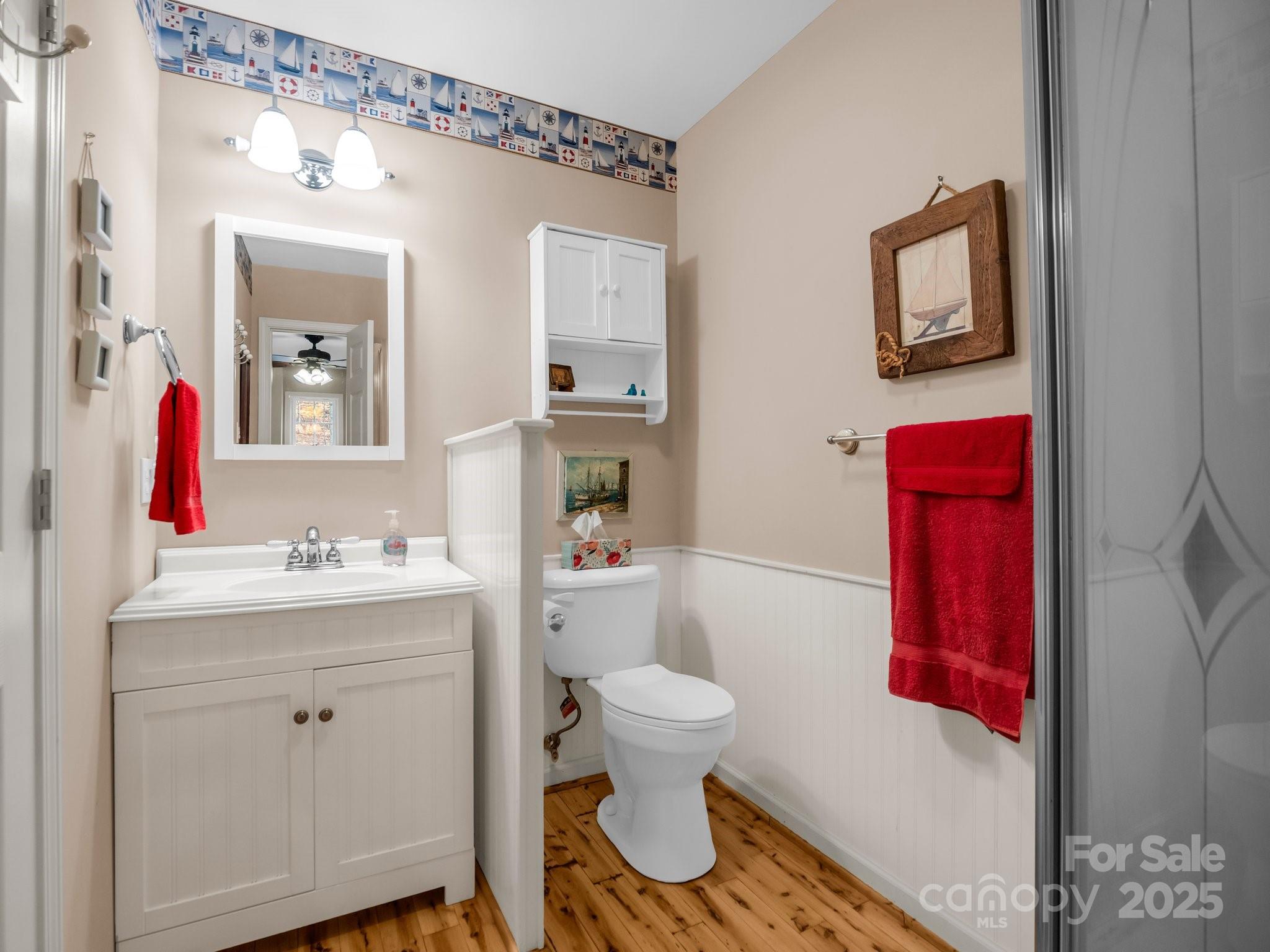 940 Hugh Champion Road Tryon, NC 28782 - Photo 25 of 36 a bathroom with a toilet a sink and a mirror
