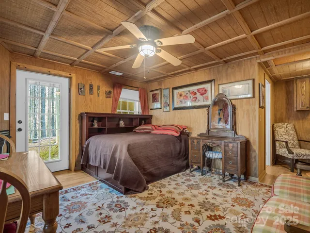 a bed room with a bed and a chair