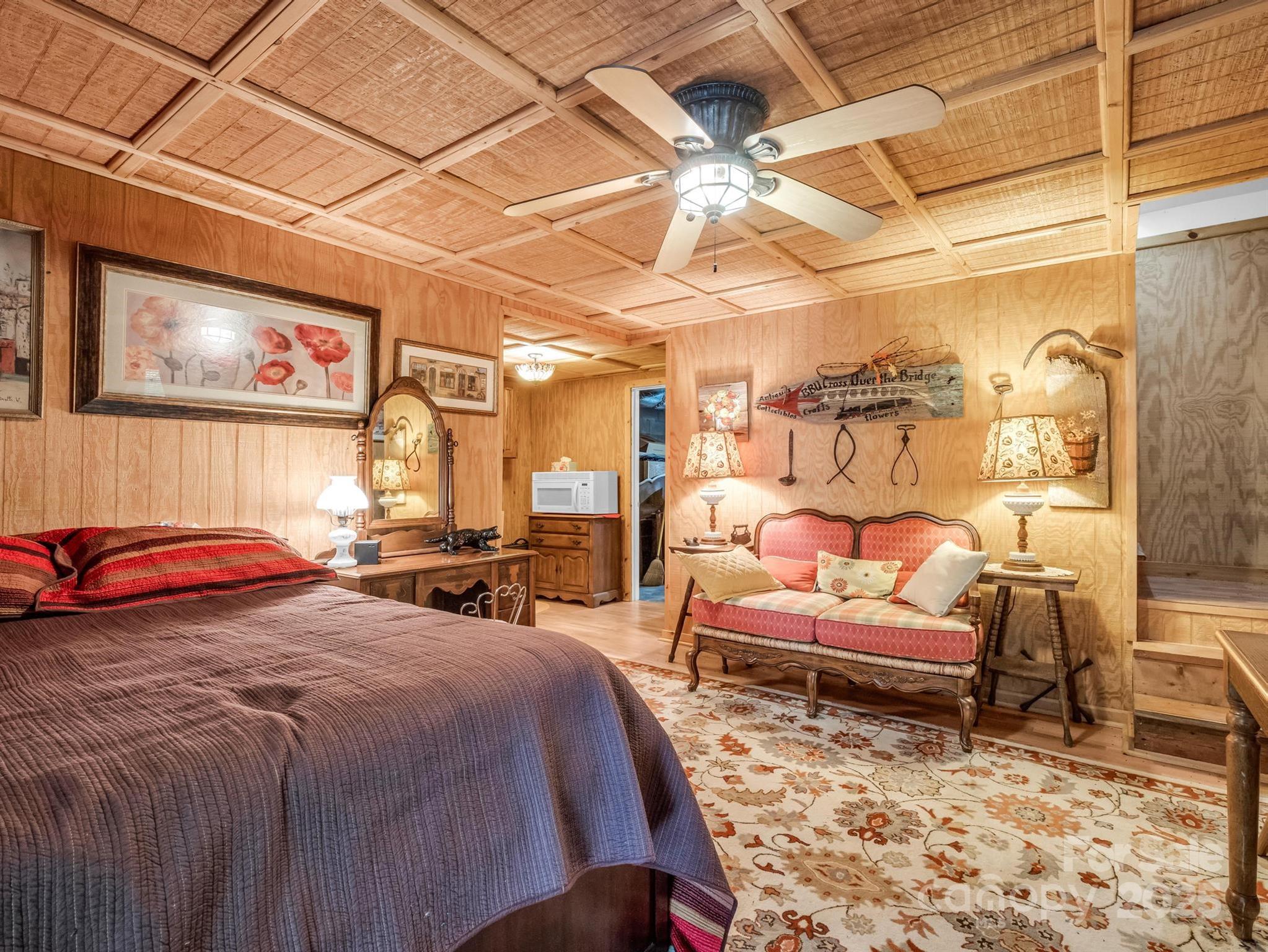 940 Hugh Champion Road Tryon, NC 28782 - Photo 30 of 36 a bed room with a bed and a chair